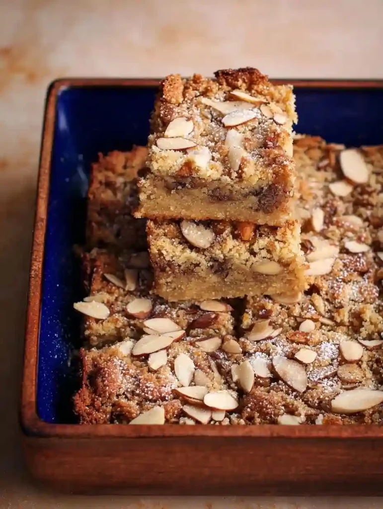 stack of almond croissant protein blondies with almond topping