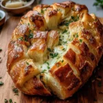 Freshly baked sourdough discard pull-apart garlic bread with herbs
